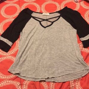 black and gray shirt with x-cross v-neck